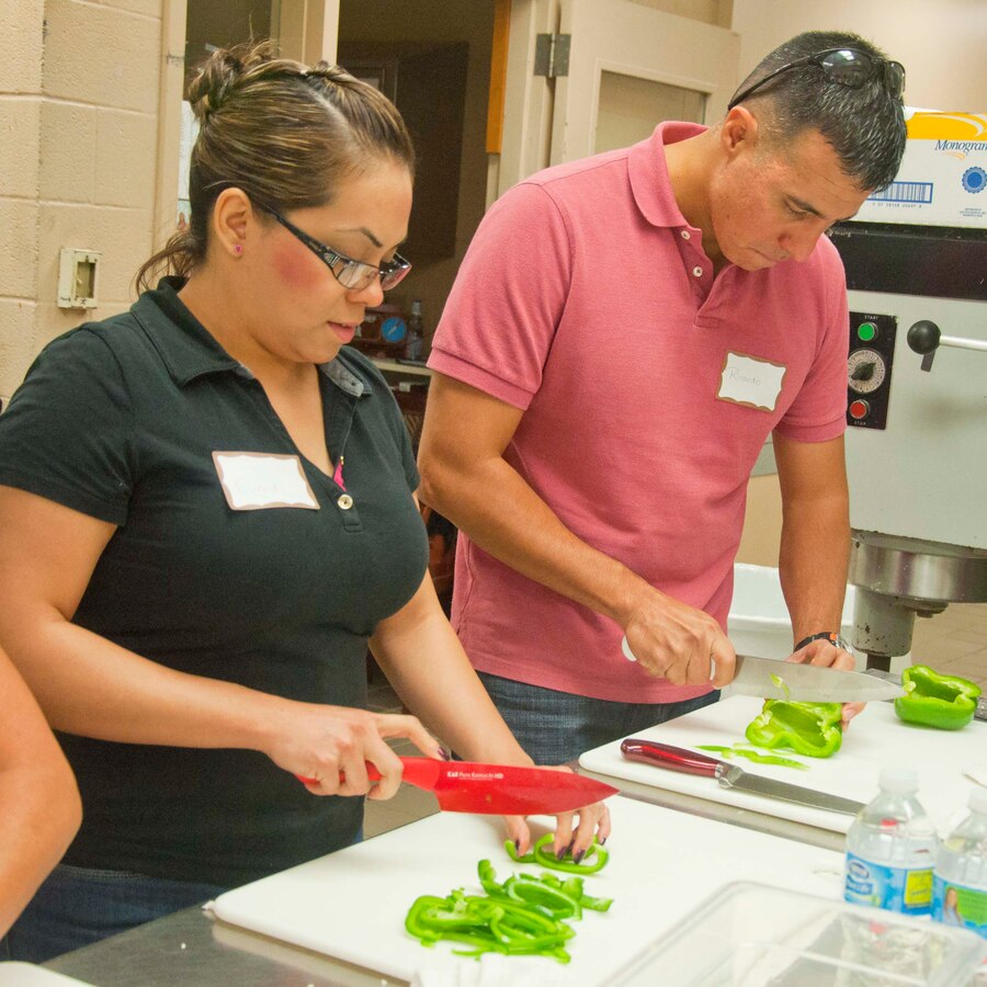 1st Lt. Ricardo Magallanes, 4th Combat Engineer Battalion, and his spouse Eunice attend a cooking class where they learn how to properly use a chef’s knife.