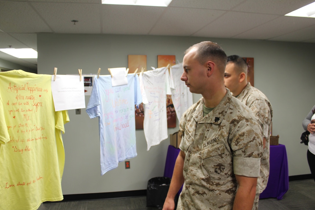 Sgt. Chris Roberts, Finance, views submissions to the Clothesline Project in the Family Advocacy Program offices aboard Marine Corps Base Quantico on Oct. 14.