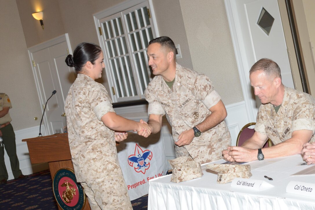 Marine Corps Base Quantico commander, Col. Joseph Murray, shakes hands with 2nd Lt. Talia Bastien, the CFC representative for the base, at the Public Pledge Ceremony at The Clubs at Quantico on Oct. 15.