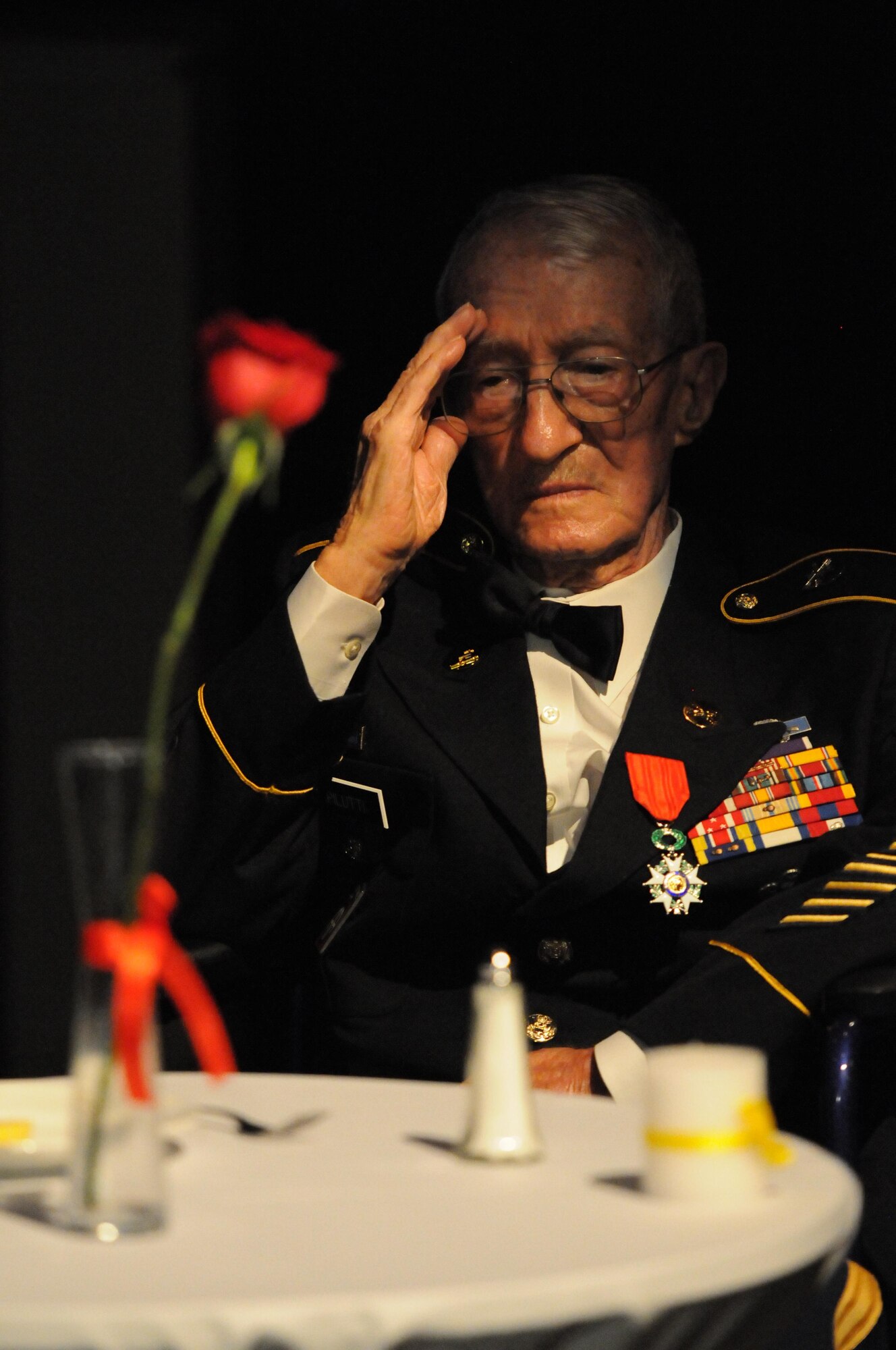 Retired Army Command Sgt. Maj. Adelchi Pilutti, World War II veteran, renders a salute during a POW/MIA tribute at the 37th Annual Salute to the Military at the Mississippi Coast Convention Center, Oct. 20, 2015, Biloxi, Miss.  The Salute to the Military recognizes the men and women who make up our military along the Gulf Coast. (U.S. Air Force photo by Kemberly Groue)