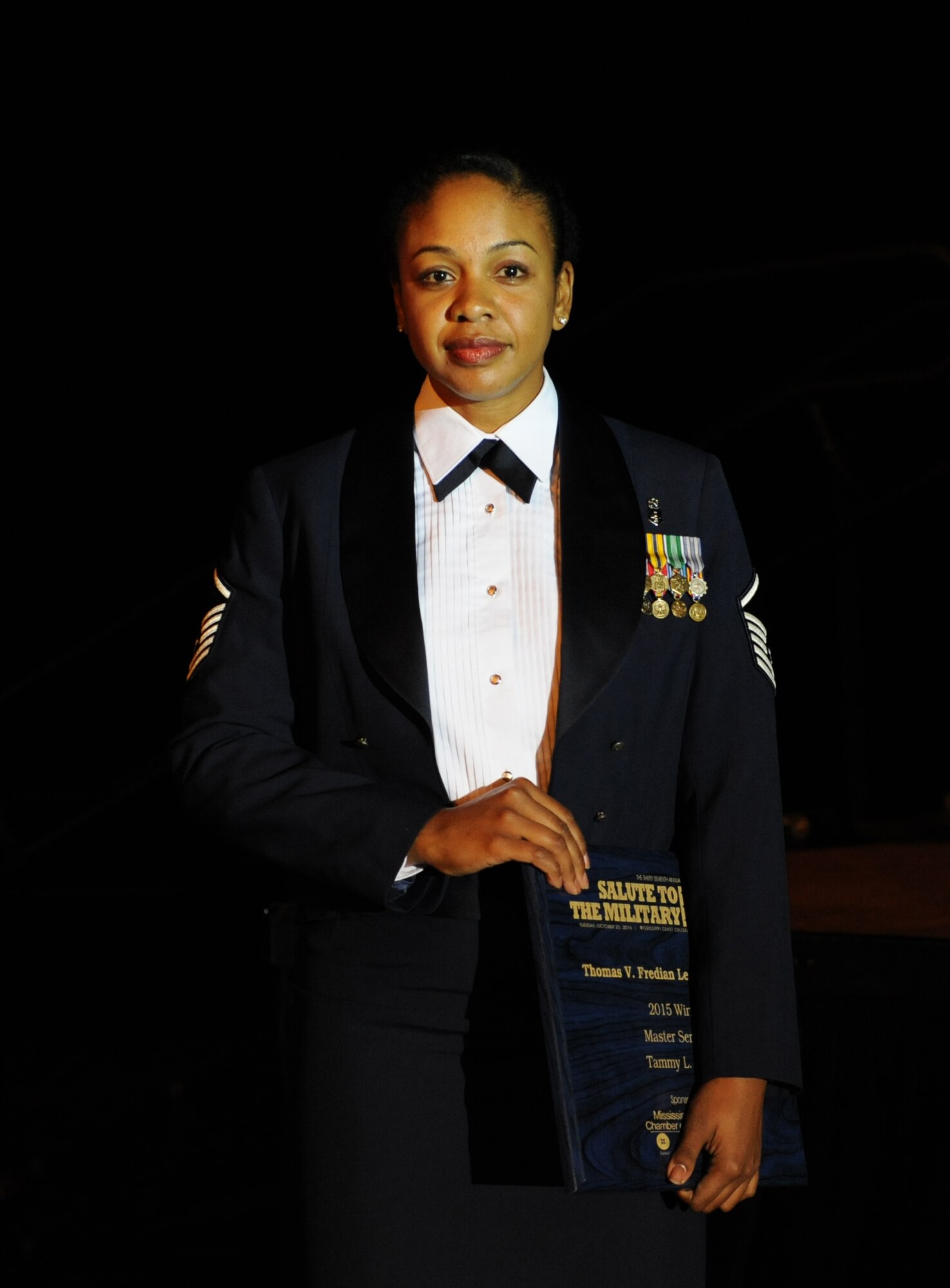 Master Sgt. Tammy Pierce, 81st Inpatient Operation Squadron medical and surgical inpatient flights flight chief, Keesler Air Force Base, Miss., holds a plaque during the 37th Annual Salute to the Military at the Mississippi Coast Convention Center, Oct. 20, 2015, Biloxi, Miss. Pierce was recognized as the winner of the Thomas V. Fredian Community Leadership Award at the event. The Salute to the Military recognizes the men and women who make up our military along the Gulf Coast. (U.S. Air Force photo by Kemberly Groue)