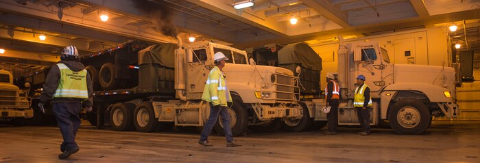 Members from the International Long Shoreman’s Association, Shippers Stevedoring Company and the 841st Transportation Battalion, are unloading all of the vehicles from the United States Naval Ship Red Cloud onto the dock of Joint Base Charleston – NWS, S.C. on Oct. 20, 2015. The Honeywell Company will move the vehicles from the dock back to the Army Strategic Logistics Activity Command headquarters for maintenance. (U.S. Air Force photo/Airman 1st Class Thomas Charlton)