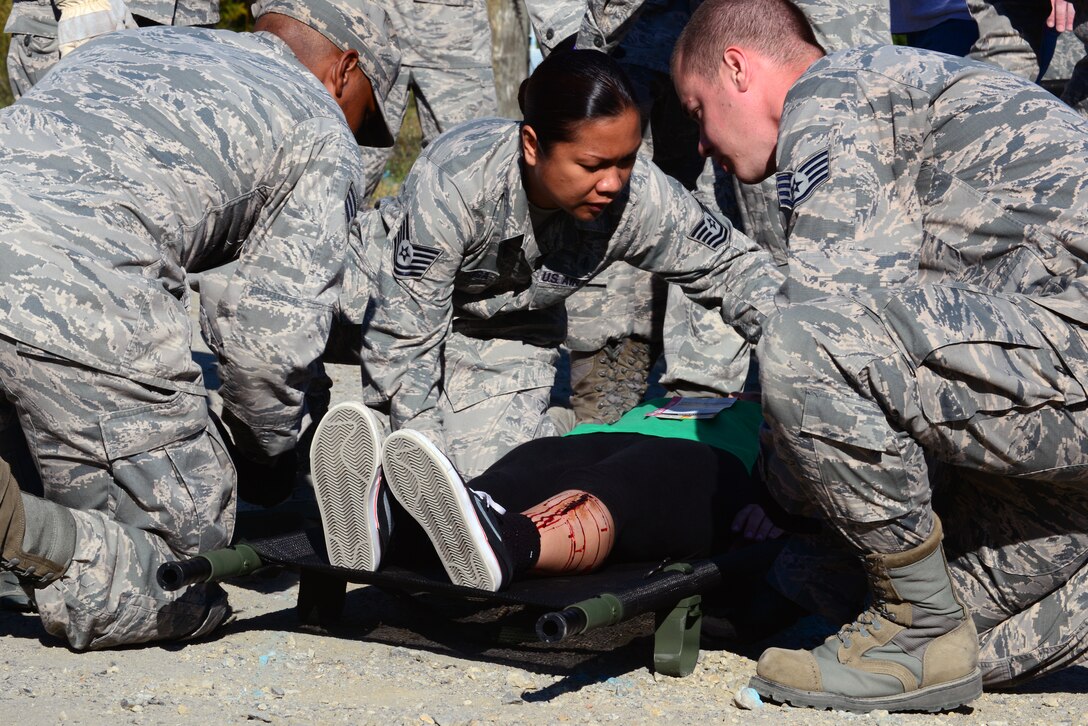 U.S. Air Force Airmen assigned to the 633rd Medical Group prepare to move a simulated patient during a mass casualty exercise at Langley Air Force Base, Va., Oct. 15, 2015. The exercise took place to test the Airmen’s real-world deployment capabilities. (U.S. Air Force photo by Senior Airman Kimberly Nagle/ Released)