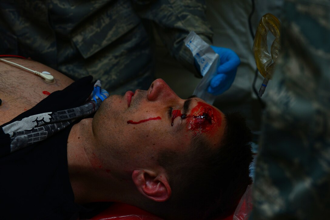 A simulated gun-shot patient received medical care from 633rd Medical Group personnel during a mass casualty exercise at Langley Air Force Base, Va., Oct. 15, 2015. Several U.S. Air Force Airmen volunteered as casualties to assist in the exercise. (U.S. Air Force photo by Senior Airman Kimberly Nagle/ Released)