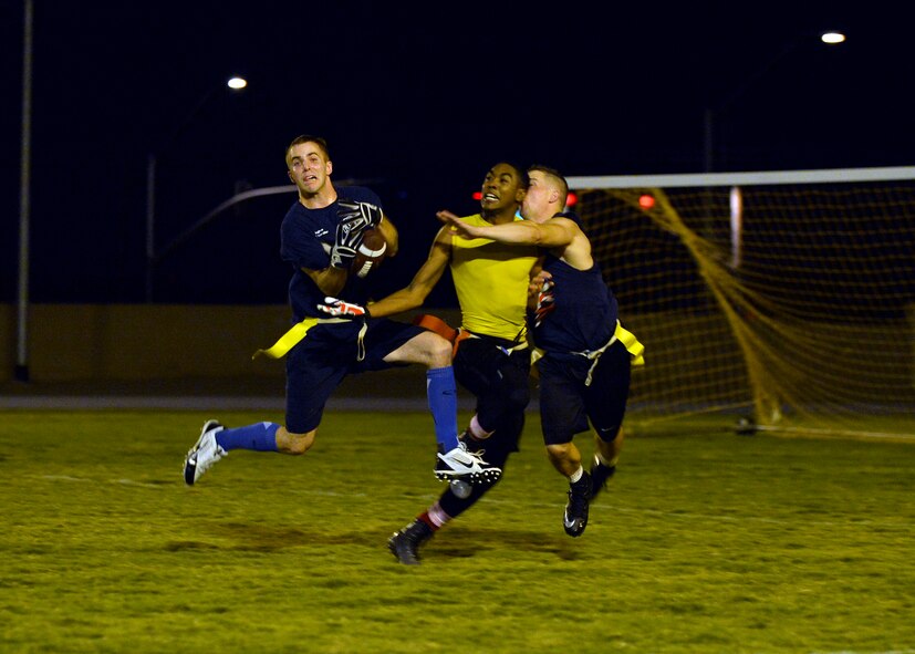 Ryan Miller, 56th Civil Engineer Squadron, attempts to intercept the football during an intramural flag football matchup against 56th Equipment Maintenance Squadron at Luke Air Force Base, Ariz., Oct. 19, 2015. EMS defeats CE 27-14. (U.S. Air Force photo by Senior Airman Devante Williams)
