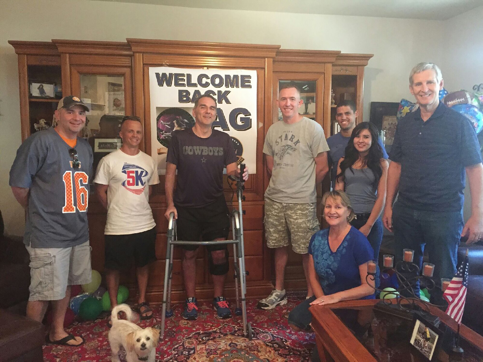 Albert Garcia poses with family, friends and Airmen from the 47th Operations Support Squadron in his home in Del Rio, Texas, Sept. 26, 2015. Garcia attributes his pre-existing physical stamina and the support of his Air Force family to his quick and miraculous recovery. (Photo provided by the Garcia family)(Released))