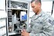 Staff Sgt. Aaron Munoz-Case, 56th Medical Support Squadron Arizona Refilling Center acting NCO in charge, adjusts the robotic arm at Luke Air Force Base, Arizona, Oct. 19, 2015. The robotic arm system helps Airmen at the ARC refill approximately 60 percent of all prescriptions. (U.S. Air Force photo by Senior Airman James Hensley)