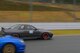 Senior Airman Thomas Kirts, 374th Civil Engineer Squadron driver operator, races a competitor at Fuji Speedway, Japan, Oct. 17, 2015. Kirts participated in two 30 minute heats, which were casual races for the enjoyment of the competitors. (U.S. Air Force photo by Airman 1st Class Elizabeth Baker/Released)