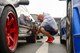 Senior Airman Thomas Kirts, 374th Civil Engineer Squadron driver operator, adjusts his tire pressure in preparation for a race at Fuji Speedway, Japan, Oct. 17, 2015. Releasing pressure in the tires compensates for the internal heating and expansion during the race, giving them better traction. (U.S. Air Force photo by Airman 1st Class Elizabeth Baker/Released)