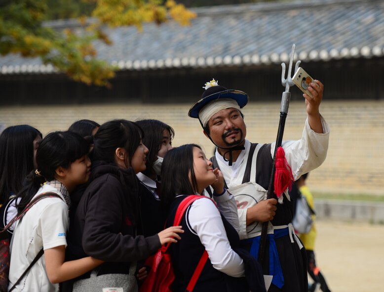 An actor takes a selfie with a group of school children at the Korean Folk Village in Yongin, Republic of Korea, Oct. 16, 2015.  The village is a place for visitors to learn the ways of a bygone era as they are immersed in the world of the Joseon dynasty. 
