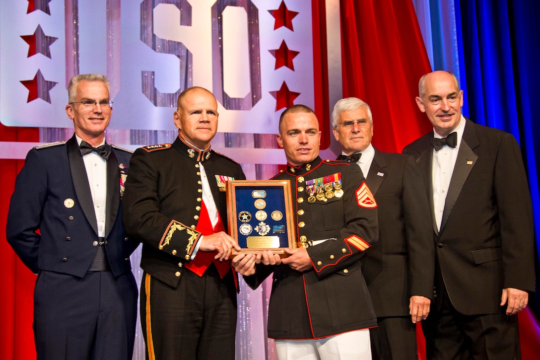 Air Force Gen. Paul Selva, left, vice chairman of the Joint Chiefs of Staff, Marine Corps Commandant Gen. Robert B. Neller, second left, and others, stop for a photo with Marine Corps Staff Sgt. Joseph P. Bednarik, center, during the 2015 USO Gala in Washington, D.C., Oct. 20, 2015. Bednarik was recognized as the USO Marine of the year during the event. U.S. Marine Corps photo by Sgt. Gabriela Garcia