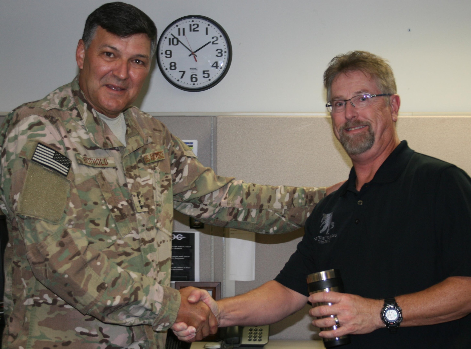 Lt. Gen. Brad Heithold, Air Force Special Operations Command commander, congratulates Wayne Barrett on receiving a Cutting Edge Award. The general presented 14 individuals awards for accomplishing command goals, delivering outstanding customer service, improving the work environment and morale and demonstrating exceptional leadership. (Courtesy photo)