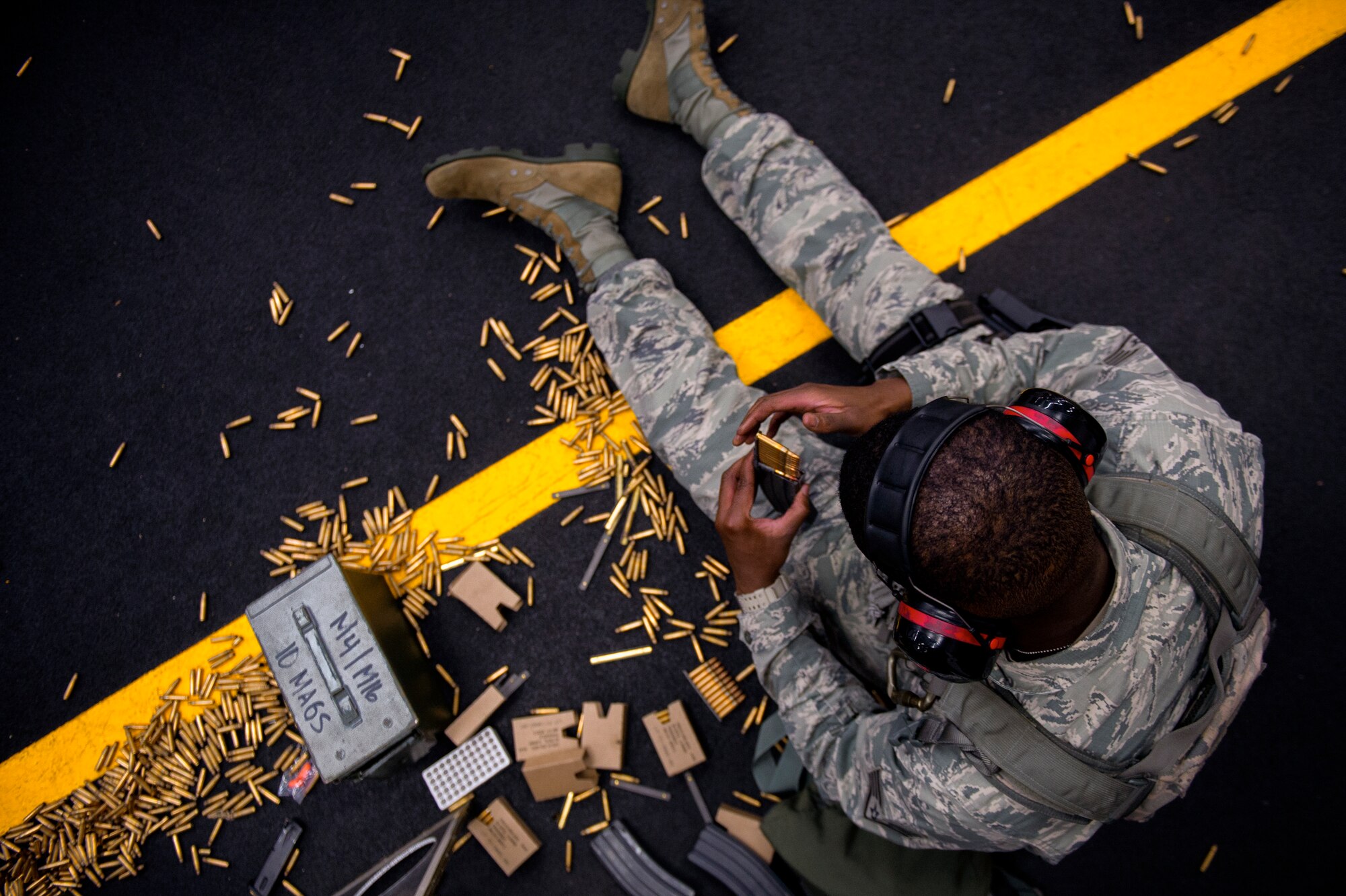 Staff Sgt. Louis Bradshaw, 374th Security Forces Squadron criminal investigator, loads rounds into a magazine at Yokota Air Base, Japan, Oct. 8, 2015. Airmen load the rounds in a magazine to be fired at a target sheet set up at a certain distance down the firing range. (U.S. Air Force photo by Airman 1st Class Delano Scott/Released)
