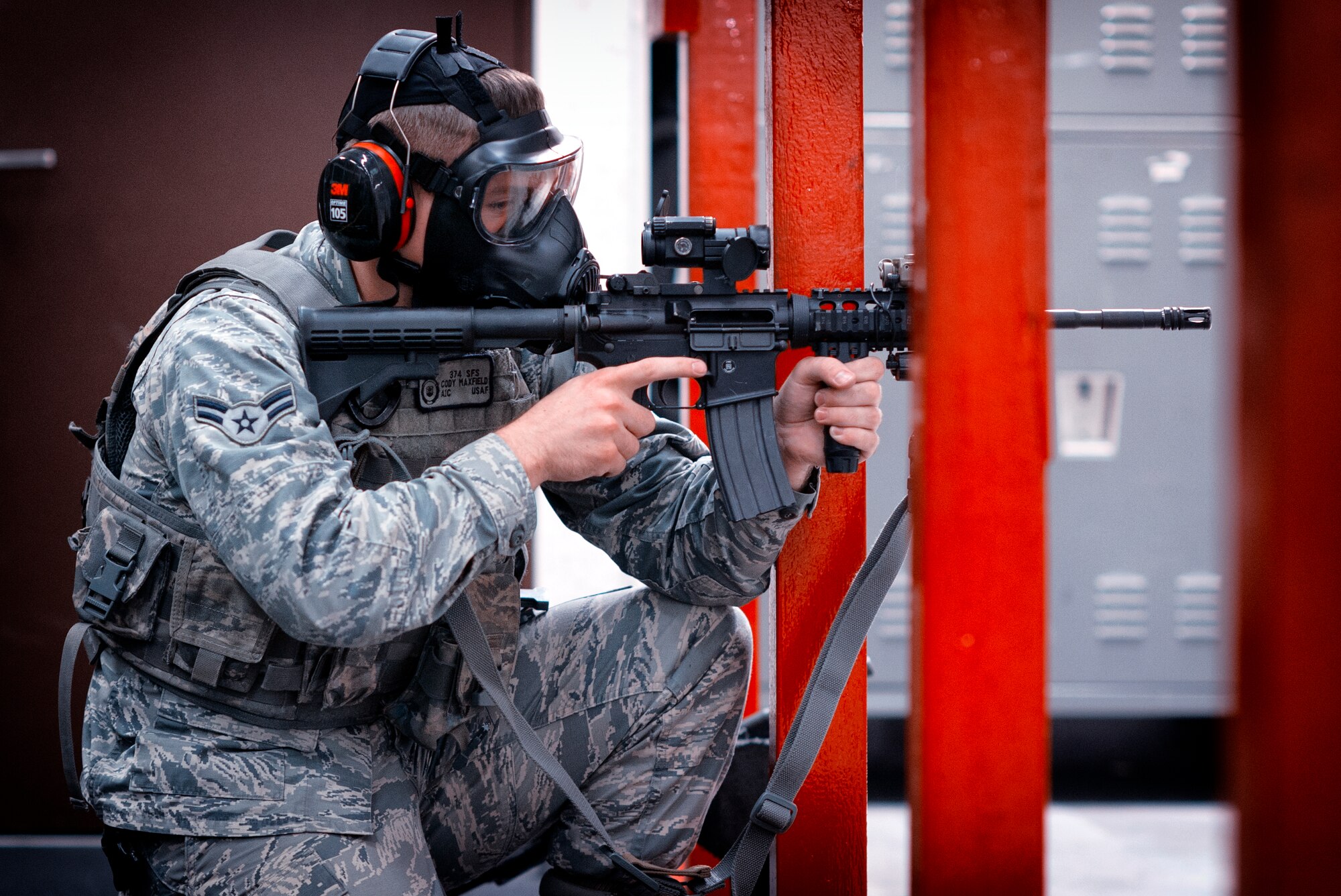 Airman 1st Class Cody Mayfield, 374th Security Forces Squadron patrolman, fires an M-4 Carbine during a Combat Arms Training and Maintenance course at Yokota Air Base, Japan, Oct. 8, 2015. Airmen have to meet minimum qualifications in order to pass the course; they must demonstrate full knowledge of safety rules, procedures and characteristics of multiple weapons and types of ammunition, while also showing target accuracy firing the weapon. (U.S. Air Force photo by Airman 1st Class Delano Scott/Released)