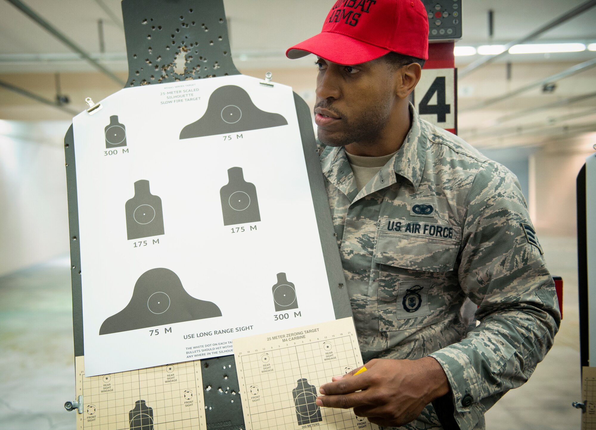 Senior Airman Dominique Adams, 374th Security Forces Squadron combat arms instructor, briefs students on proper weapon aiming and positioning techniques at Yokota Air Base, Japan, Oct. 8, 2015. The combat arms maintenance and training trains between 2,500 - 3,000 students each year. (U.S. Air Force photo by Airman 1st Class Delano Scott/Released)