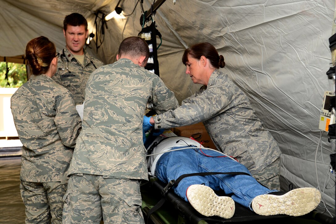 U.S. Air Force Airmen assigned to the 633rd Medical Group discuss and assess a simulated patient during a mass casualty exercise at Langley Air Force Base, Va., Oct. 15, 2015. During the exercise, medical personnel were encouraged to treat the simulated patients in a timely manner. (U.S. Air Force photo by Senior Airman Kimberly Nagle/ Released)