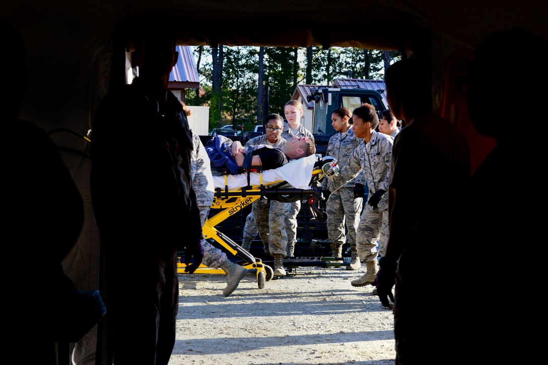 U.S. Air Force Airmen assigned to the 633rd Medical Group begin to triage a simulated patient at Langley Air Force Base, Va., Oct. 15, 2015. The medical personnel took part in the exercise as a way to stay proficient in patient support in deployed settings. (U.S. Air Force photo by Senior Airman Kimberly Nagle/ Released)