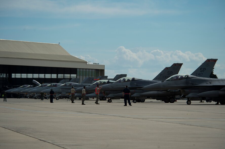 BEJA AIR BASE, Portugal - F-16 fighter aircraft from multiple nations perform last-minute checks before take off in support of Exercise Trident Juncture 15 at Beja Air Base, Portugal, Oct. 21, 2015. More than 30 NATO and partner nations are participating in this year's exercise. Exercises like Trident Juncture 15 ensures America's commitment to security in the region.  (U.S. Air Force photo by Airman 1st Class Luke Kitterman/Released)