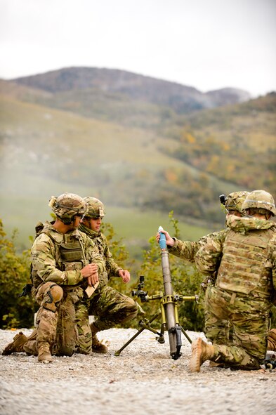 U.S. Army Specialist Nigeal Yago, 2nd Battalion 503rd mortarman, left, directs his mortar crew during a live fire training scenario Oct. 19, 2015 at Pocek Training Range, near Postojna, Slovenia. Mortarmen from the 2nd Battalion, 503rd Infantry Regiment supported exercise Rock Proof V with indirect fire as other assets provided close air support, artillery and machine gun fire. The exercise was designed to build interoperability between U.S. and Slovenian militaries and maintain strong ties between NATO allies. (U.S. Air Force photo/ Staff Sgt. Armando A. Schwier-Morales)