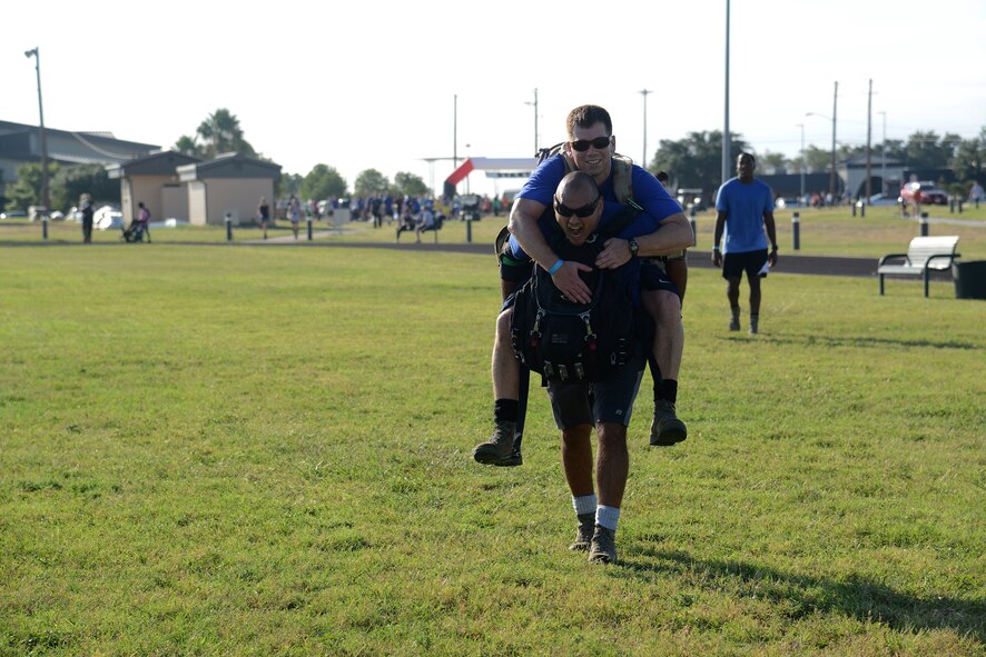 Competitors in the 2015 Wingman Challenge, conduct the buddy carry challenge on Laughlin Air Force Base, Texas, Oct. 17, 2015. This year’s challenge consisted of a 5k run and a 10K run/ruck with transition challenges, including buddy carries, push-ups, sit-ups, and planks. (U.S. Air Force photo by Airman 1st Class Ariel D. Partlow)(Released)