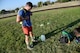 Staff Sgt. Shon Nguyen, 47th Medical Group aerospace medical technician, puts on his ruck gear on Laughlin Air Force Base, Texas, Oct. 17, 2015. Competitors weighing 150 pounds and over were required to carry a 20-pound rucksack; and those weighing under 150 pounds were required to carry a 10-pound rucksack. (U.S. Air Force photo by Airman 1st Class Ariel D. Partlow)(Released)