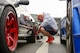 Senior Airman Thomas Kirts, 374th Civil Engineer Squadron driver operator, adjusts his tire pressure in preparation for a race at Fuji Speedway, Japan, Oct. 17, 2015. Releasing pressure in the tires compensates for the internal heating and expansion during the race, giving them better traction. (U.S. Air Force photo by Airman 1st Class Elizabeth Baker/Released)