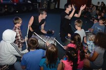 The punk rock percussion band Street Drum Corps interacts with Andersen children Oct. 20, 2015, at Andersen Air Force Base, Guam. The free event was hosted by Navy Entertainment and drew a crowd of 150 people. (U.S. Air Force photo by Airman 1st Class Arielle Vasquez/Released)