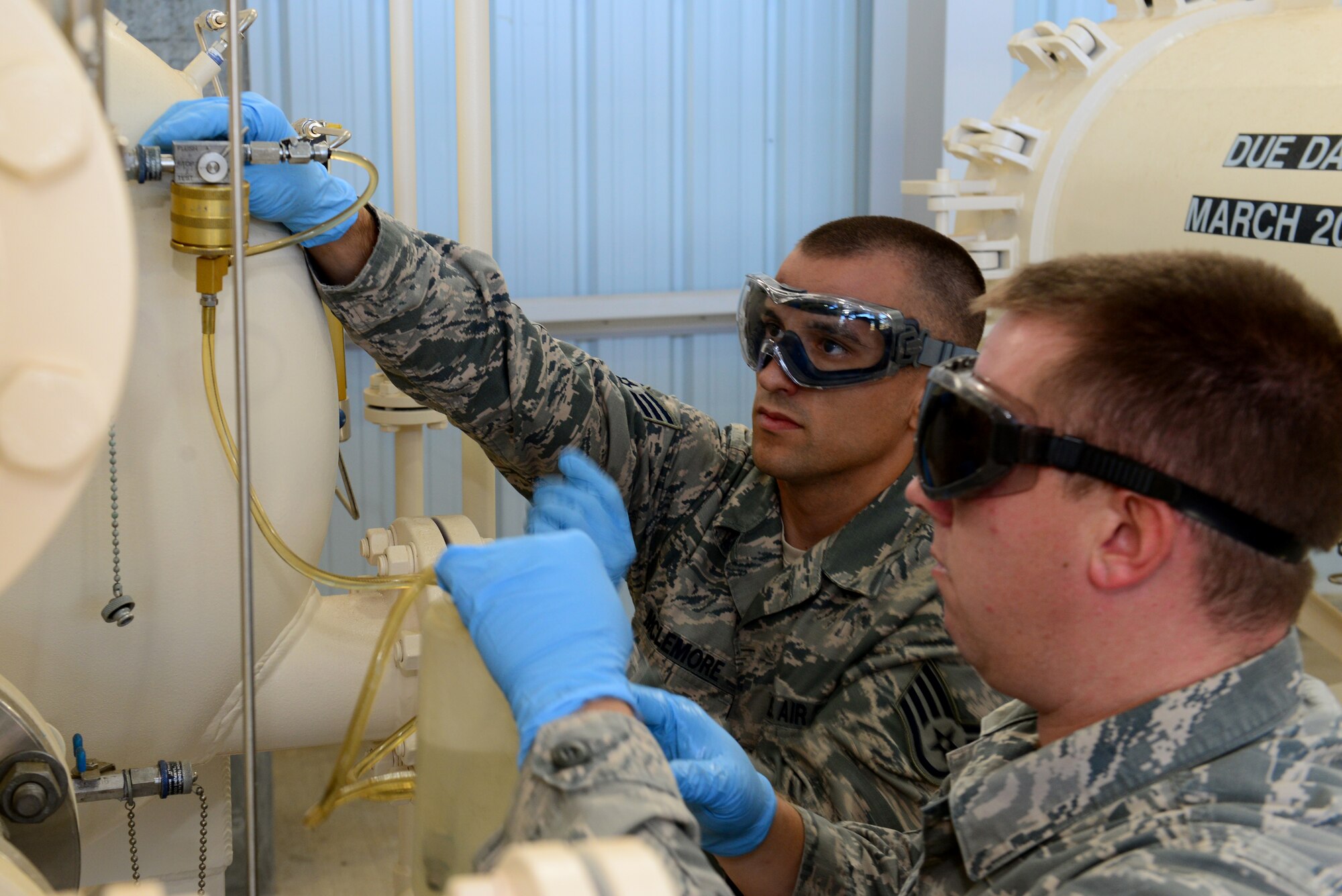 Staff Sgts. Derek Mclemore, left, and Jermey Manning, 2nd Logistics Readiness Squadron fuels laboratory technicians, prepare to take a fuel sample at Barksdale Air Force Base, La., Oct. 14, 2015. Jet fuel is tested on a regular basis to ensure it doesn’t contain any unsafe amounts of water or particles. (Air Force Photo/Airman 1st Class Luke Hill)