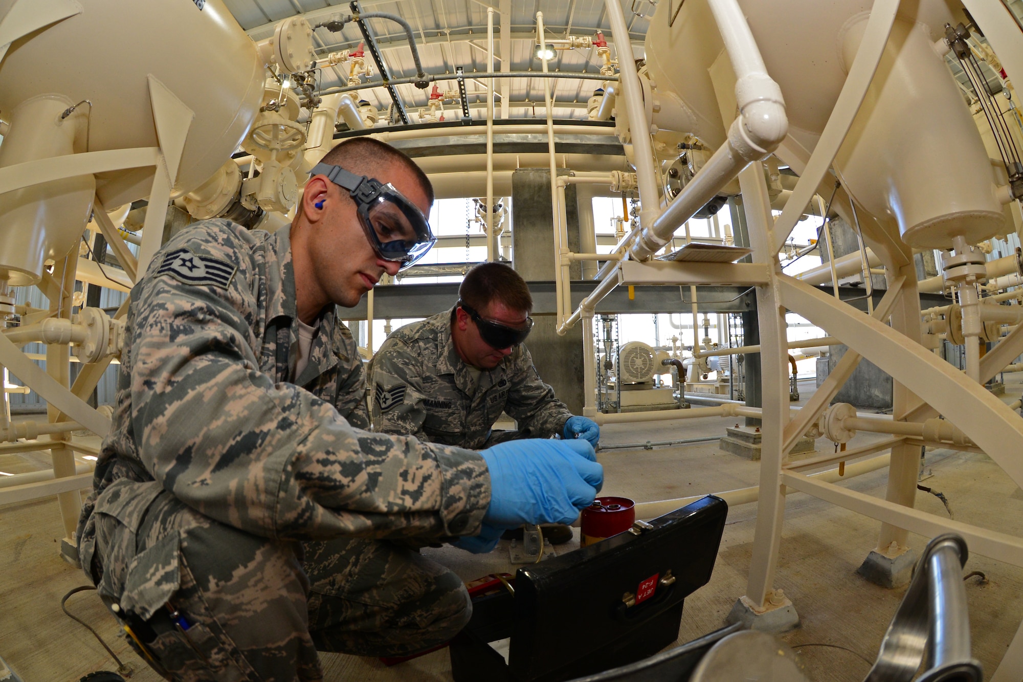 Staff Sgts. Derek Mclemore, left, and Jermey Manning, 2nd Logistics Readiness Squadron fuels laboratory technicians, prepare to extract a fuel sample at Barksdale Air Force Base, La., Oct. 14, 2015. Fuels lab technicians must be careful as they extract samples to make sure no outside debris taints the sample. (Air Force Photo/Airman 1st Class Luke Hill)