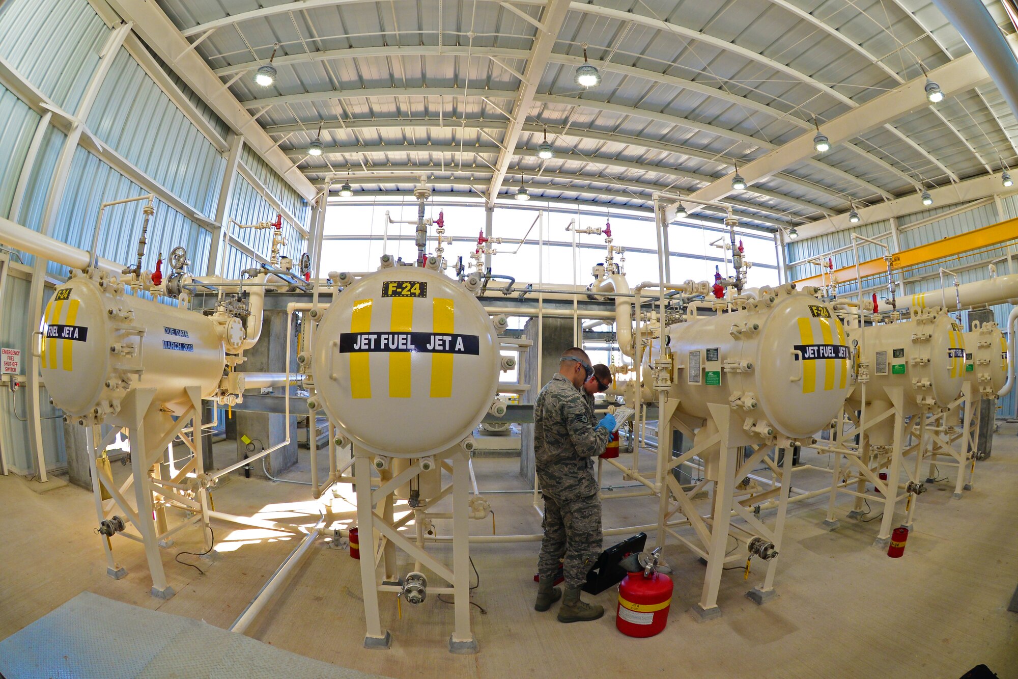 Staff Sgts. Derek Mclemore, left, and Jermey Manning, 2nd Logistics Readiness Squadron fuels laboratory technicians, take jet fuel samples at Barksdale Air Force Base, La., Oct. 14, 2015. Jet fuel pump houses provide fuel filtering and delivery from storage tanks to military planes and fuel trucks. (Air Force Photo/Airman 1st Class Luke Hill)