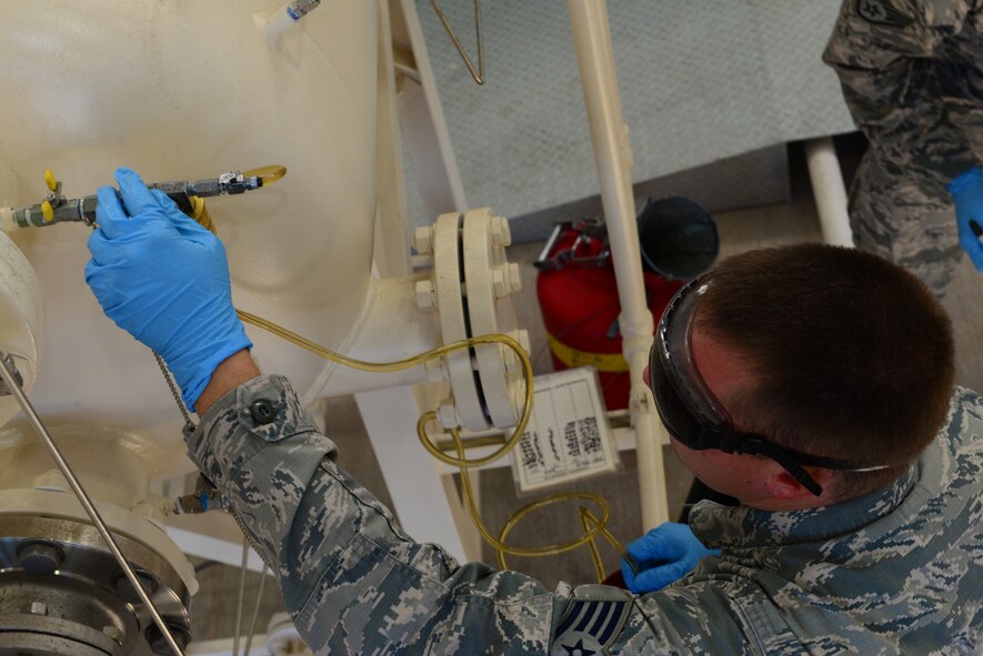 Staff Sgt. Jermey Manning, 2nd Logistics Readiness Squadron fuels laboratory technician, siphons jet fuel from a pump at Barksdale Air Force base, La., Oct. 14, 2015. The B-52 Stratofortress can carry 47,975 gallons of fuel and the pump house is capable of providing the fuel quickly. (Air Force Photo/Airman 1st Class Luke Hill)