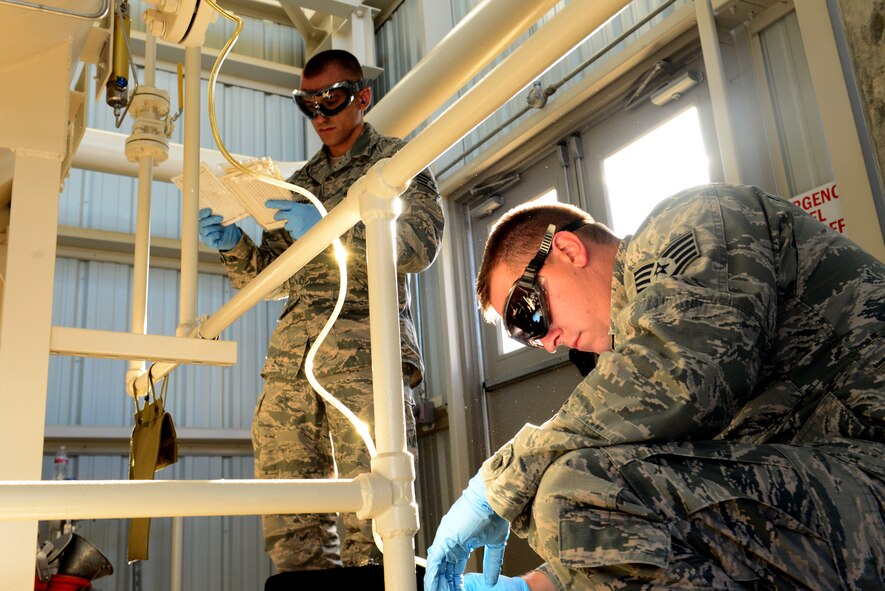 Staff Sgts. Derek Mclemore, left, and Jermey Manning, 2nd Logistics Readiness Squadron fuels laboratory technicians, record how much fuel is taken from Pump House 1 at Barksdale Air Force Base, La., Oct. 14, 2015. Fuel lab technicians not only guarantee fuel is clean and ready for use but also that the right amount of fuel can be transported when needed. (Air Force Photo/Airman 1st Class Luke Hill)