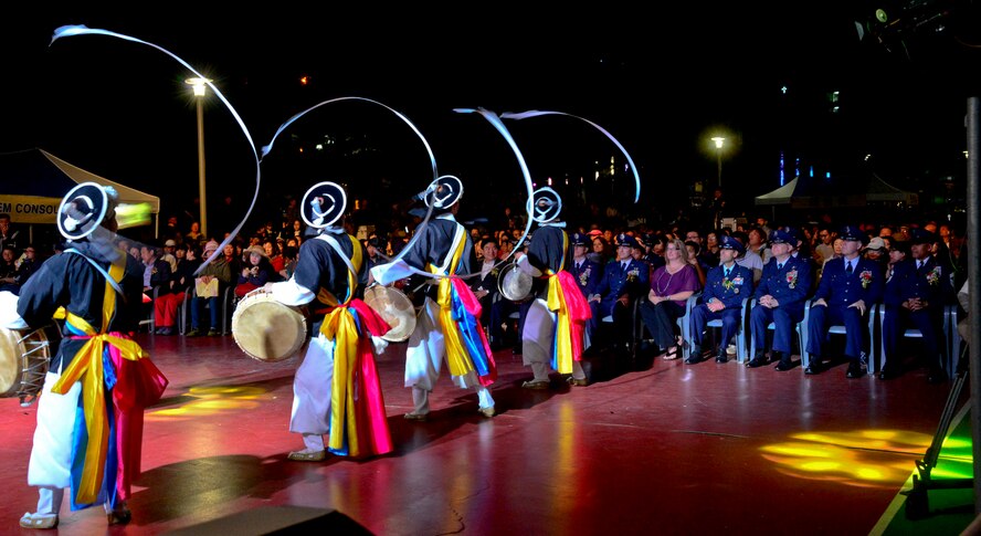 Men perform a Pungmul dance during the 12th annual Korean American Friendship Festival in the Songtan Entertainment District, Republic of Korea Oct. 17, 2015. Pungmul is a Korean folk music tradition that includes drumming, dancing, and singing. Most performances are outside, with dozens of players, all in constant motion. Pungmul was originally played as part of farm work, on rural holidays, at other village community-building events, and to accompany shamanistic rituals, mask dance dramas and other types of performances. (U.S. Air Force photo/Senior Airman Kristin High)