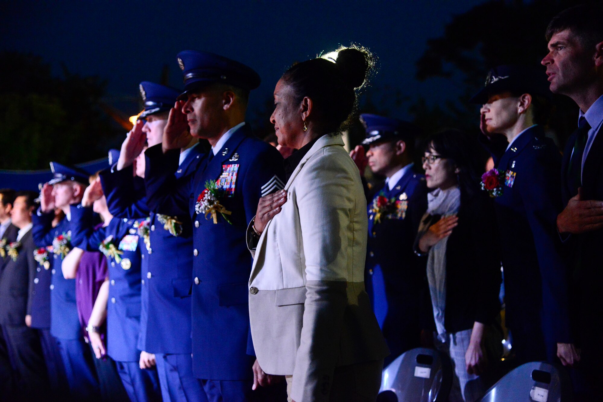 Osan Air Base leaders salute during the playing of the U.S. national anthem at the 12th annual Korean American Friendship Festival in the Songtan Entertainment District, Republic of Korea Oct. 17, 2015. The festival, hosted by the Songtan Chamber of commerce, featured American and Korean stage performers, martial arts demonstrations, cultural food and entertainment booths, which gave Americans and Koreans a look into each other’s culture. (U.S. Air Force photo/Senior Airman Kristin High)