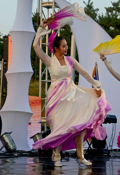 A Korean woman performs a traditional dance during the 12th annual Korean American Friendship Festival in the Songtan Entertainment District, Republic of Korea, Oct. 17, 2015. Most traditional Korean dances are performed by females mimicking various birds or flowers while wearing vibrant colors. (U.S. Air Force photo/Senior Airman Kristin High)