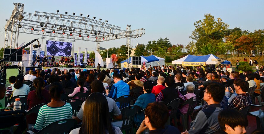 Community members watch performers dance during the 12th annual Korean American Friendship Festival in the Songtan Entertainment District, Republic of Korea, Oct. 17, 2015. The festival slogan, “Gatchi kapshida, Choen eeut doepshida” translates to “We go together, Be a good neighbor,” is said to reinforce the bond between the U.S. and the ROK. (U.S. Air Force photo/Senior Airman Kristin High)
