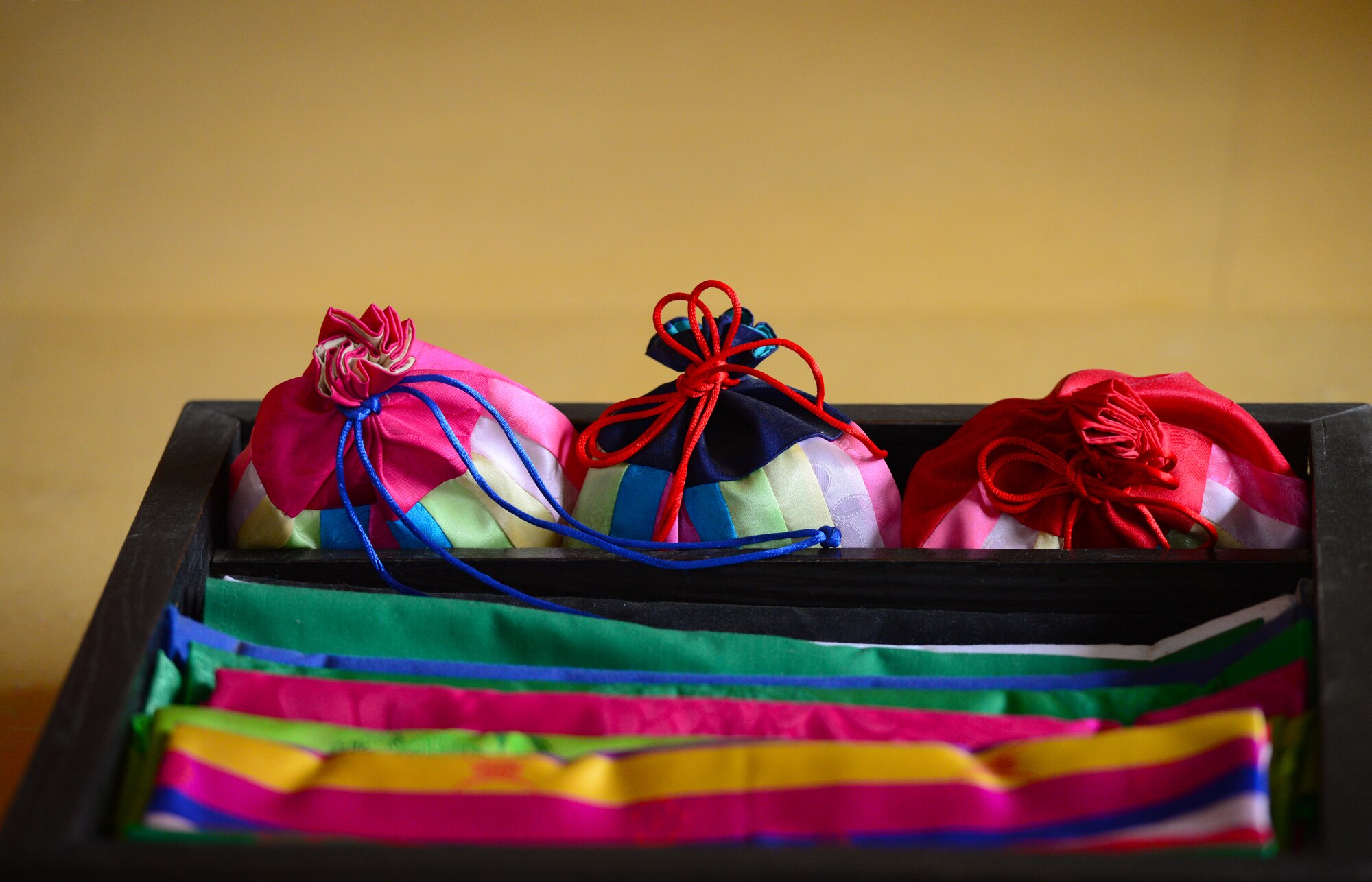A tray of rich silk clothes and purses are displayed in the recreated room of a noble girl from the Joseon dynasty at the Korean Folk Village in Yongin, Republic of Korea, Oct. 16, 2015.  The village is a place for visitors to learn the ways of a bygone era as they are immersed in the world of the Joseon dynasty.
(U.S. Air Force photo/Staff Sgt. Amber Grimm)