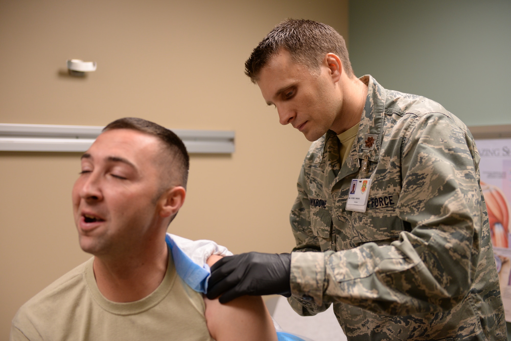 Maj. Patrick Finkbone, 56th MDOS orthopedic surgeon, provides a patient with an injection Oct. 19, 2015 at Luke Air Force Base. The orthopedic surgery clinic provides a variety of treatments and procedures to reconstruct broken bones and ligaments. (U.S. Air Force photo by Airman 1st Class Ridge Shan)