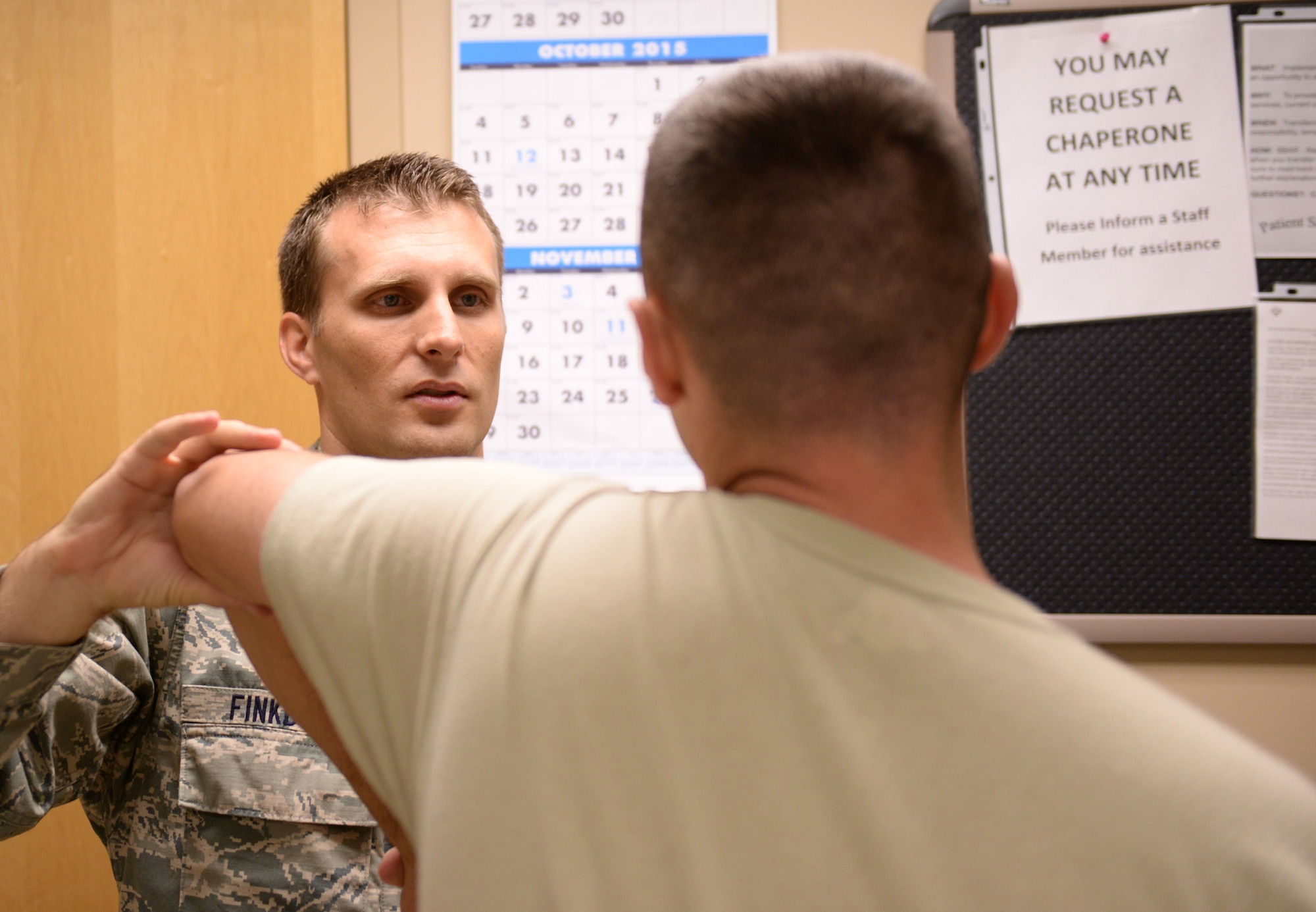 Maj. Patrick Finkbone, 56th MDOS orthopedic surgeon, examines the mobility in a patient’s arm Oct. 19, 2015, at Luke Air Force Base. Finkbone is one of three serving orthopedic surgeons at the clinic on Luke. (U.S. Air Force photo by Airman 1st Class Ridge Shan)