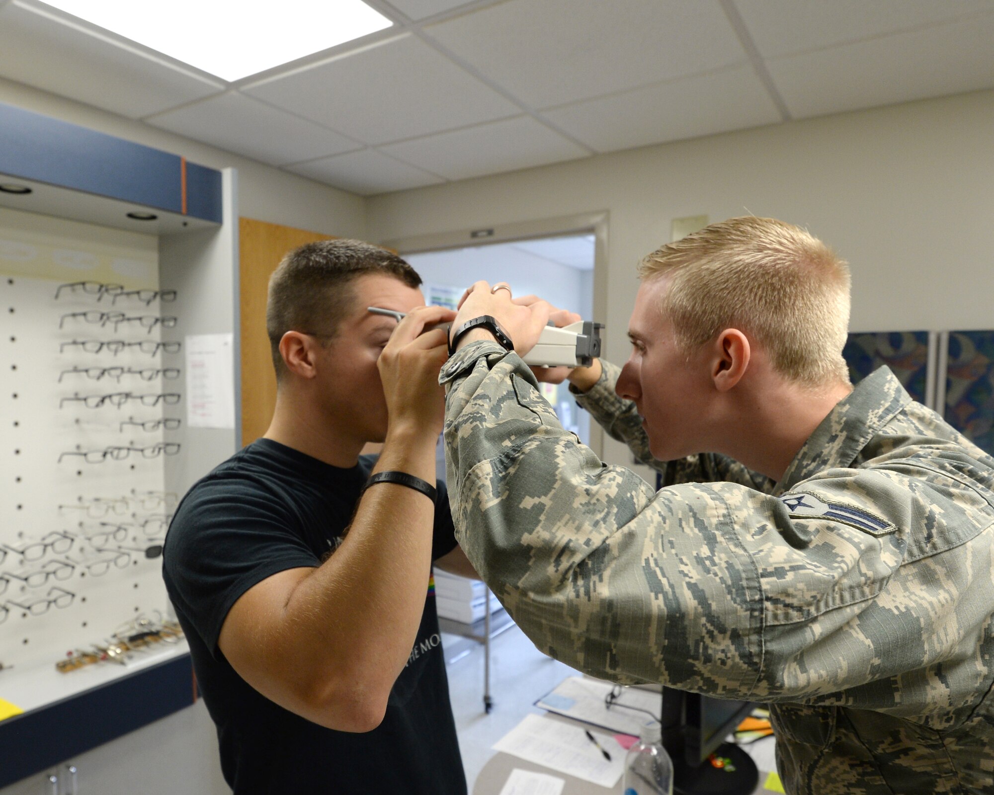 Airman 1st Class Jordan Cutaia, 325th Aerospace Medicine Squadron optometry technician, uses a device to gauge a patient’s eyesight Sept. 30.  Optometry technicians like Cutaia are responsible for processing eyewear prescriptions for military spectacles; they also perform and manage optometry clinic activities. 325th AMDS provide medical, dental, and preventive care, enabling all wing and associate units to maximize readiness and combat capability. (U.S. Air Force photo by Airman 1st Class Cody R. Miller/Released)