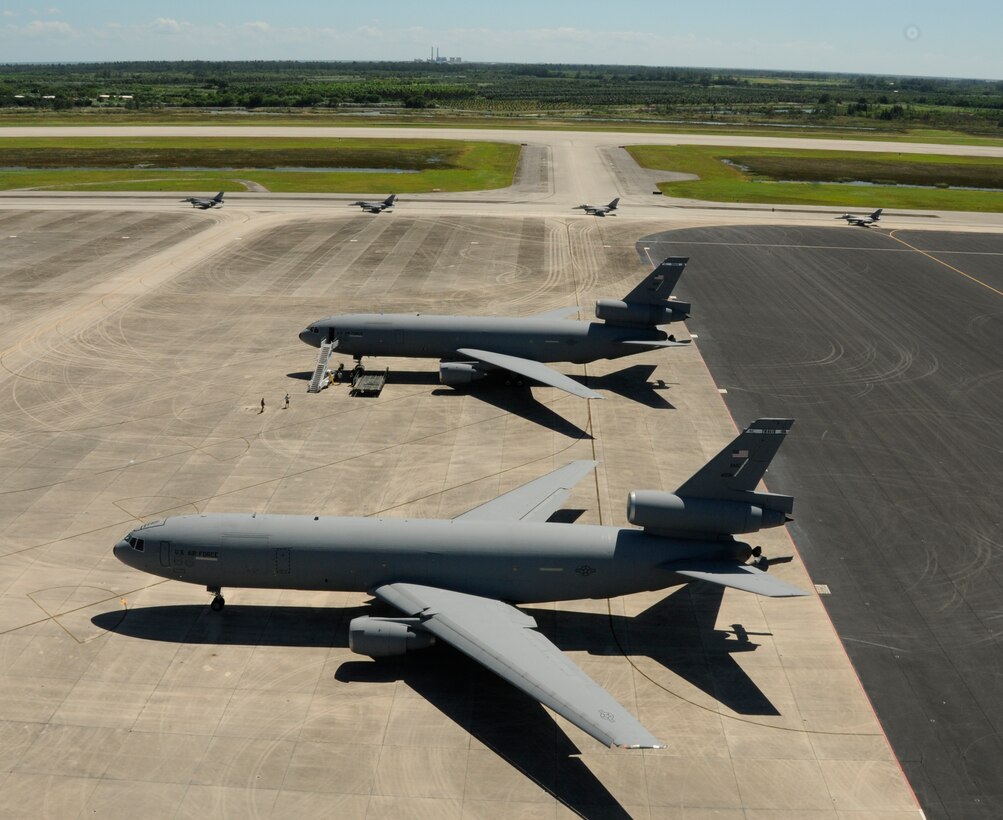 Two KC-10 Extenders from Travis Air Force Base, California, sit while four F-16 Fighting Falcons pass on the flightline in preparation for a flight to Nellis Air Force Base, Nevada, to help instruct student pilots attending the weapons course Oct. 9 at Homestead Air Reserve Base, Florida. The 12 F-16s and pilots who assisted with the course returned here Oct. 18. (U.S. Air Force photo by Senior Airman Frank Casciotta)  