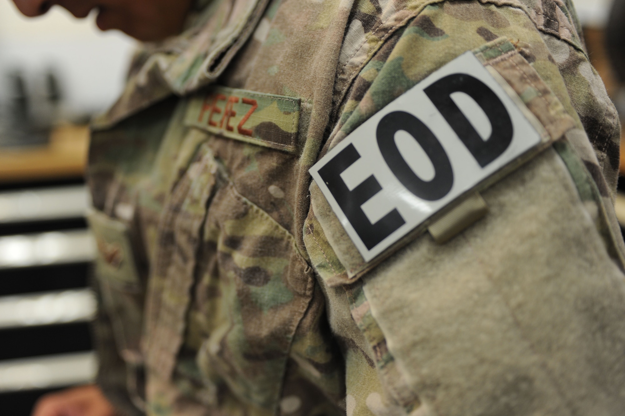 Airman 1st Class Andrew Perez, 28th Civil Engineer Squadron explosive ordnance disposal technician, dons an Operational Camouflage Pattern uniform prior to a training exercise at Ellsworth Air Force Base, S.D., Oct. 6, 2015. The EOD holds exercises twice a week to improve mission readiness. (U.S. Air Force photo by Airmen Sadie Colbert/Released)