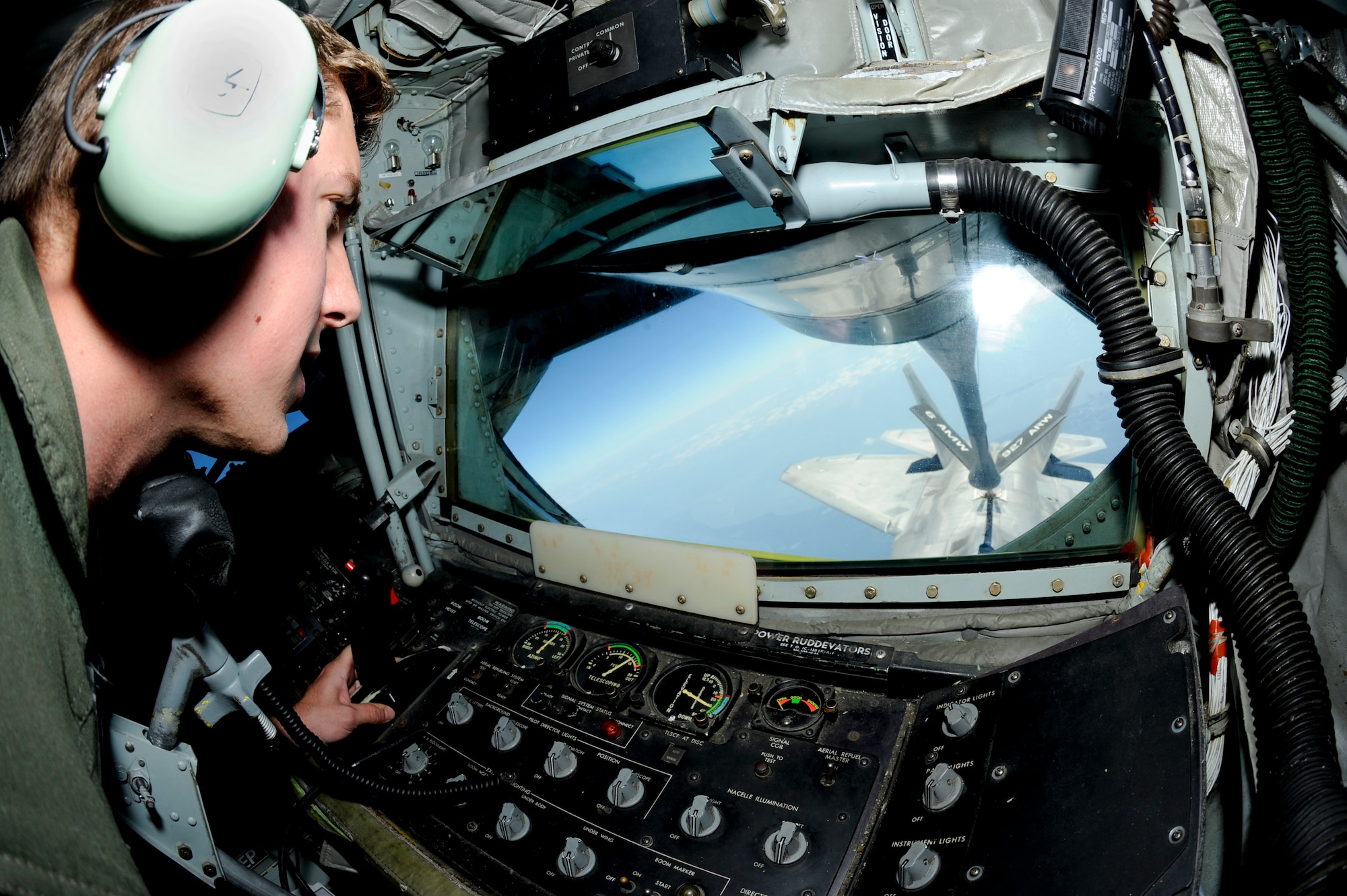Senior Airman Evan Simpson, 91st Air Refueling Squadron boom operator, refuels an F-22 Raptor, Oct. 13, 2015. The KC-135 Stratotanker is capable of carrying 150,000 pounds of transfer fuel. (U.S. Air Force photo by Airman 1st Class Mariette M. Adams/Released)