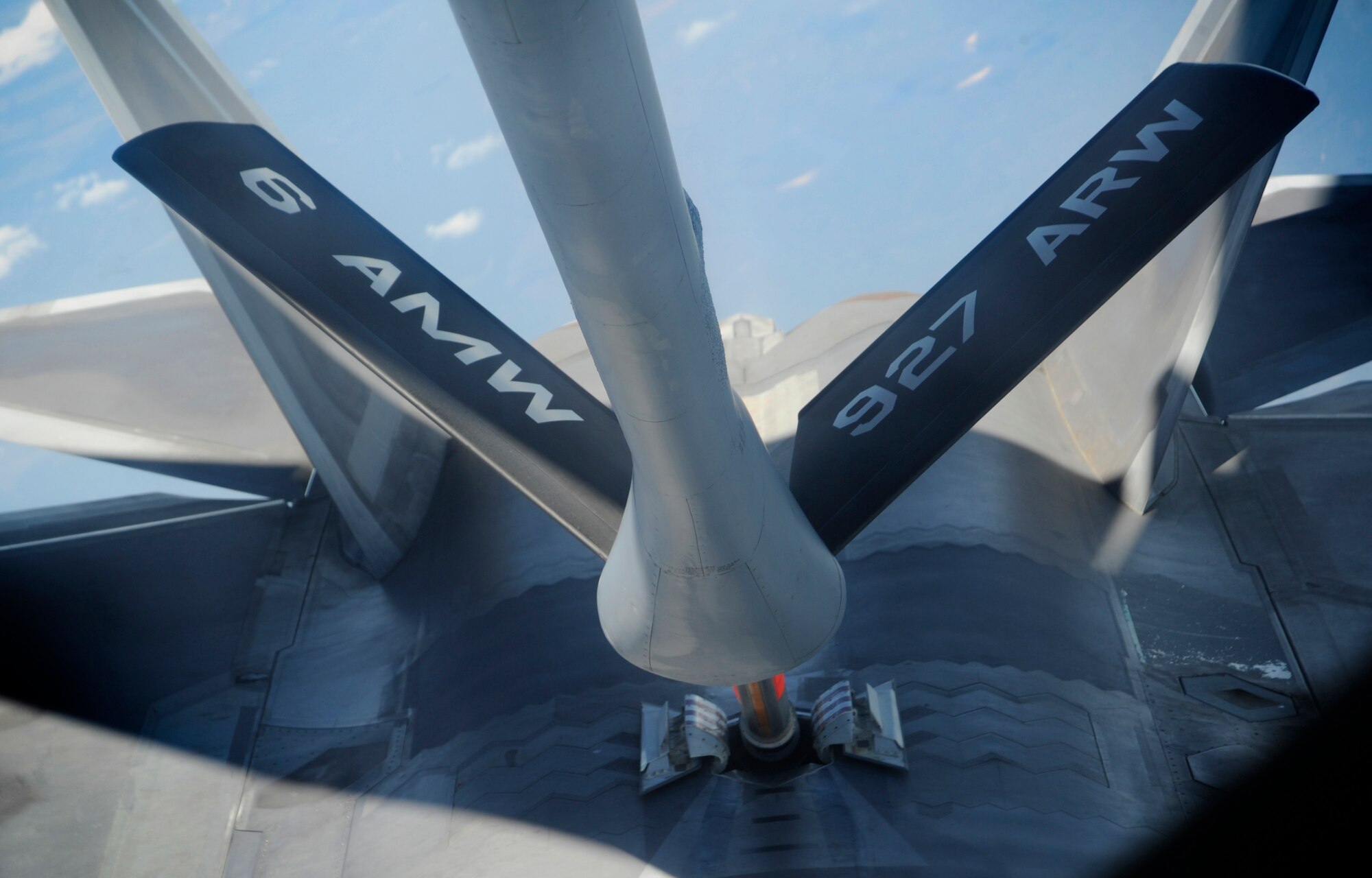 A KC-135 Stratotanker refuels an F-22 Raptor, Oct. 13, 2015. The KC-135 operates a boom that attaches and delivers gas to other aircraft during flight. (U.S. Air Force photo by Airman 1st Class Mariette M. Adams/Released)
