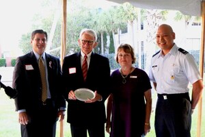 (Left to right) Scott Isaacks, Ralph H. Johnson VA Medical Center director,  Joe Riley, Charleston mayor, Glenn Jeffries, USACE Corporate Communication director and Col. Jimmy Canlas, 437th AW deputy commander, pose for a photo during the first annual Federal Executive Association of the Greater Charleston Area stakeholder meet-and-greet event at U.S. Coast Guard Sector, Charleston, S.C.  The FEA is comprised of the leadership from 40 military and civilian federal entities in the Charleston area. Jeffries and Canlas are the current FEA co-chairs. (Courtesy Photo)