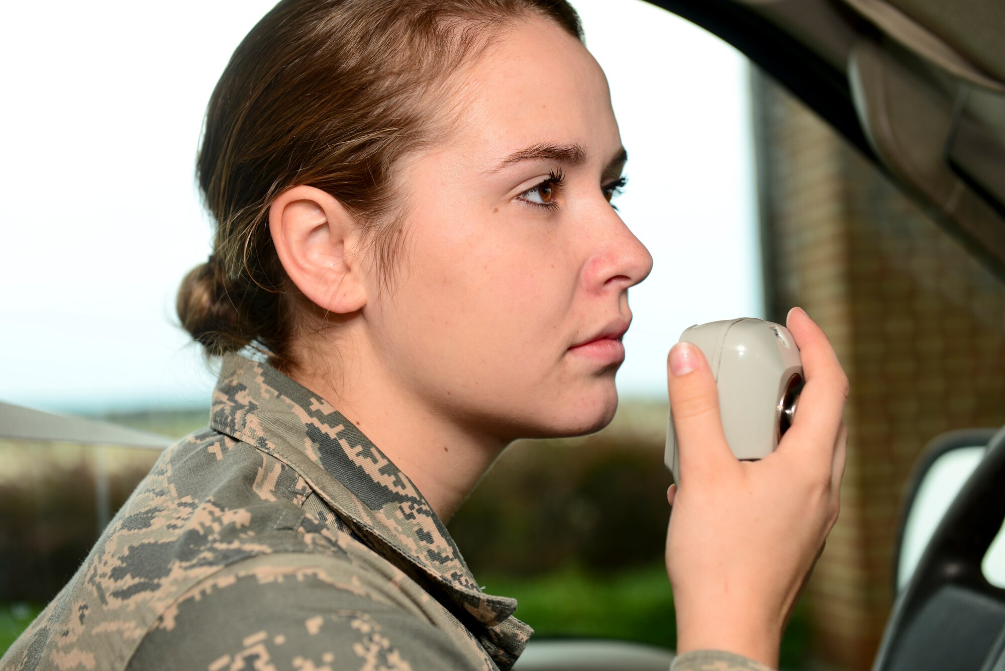 U.S. Air Force Airman 1st Class Alison Coombs, 1st Operations Support Squadron Airfield Management shift lead, awaits approval to enter the flight line at Langley Air Force Base, Va., Oct. 16, 2015. Airfield management specialists ensure the flight line is safe for pilots to land and take-off. (U.S. Air Force photo by Airman 1st Class Derek Seifert/ Released)