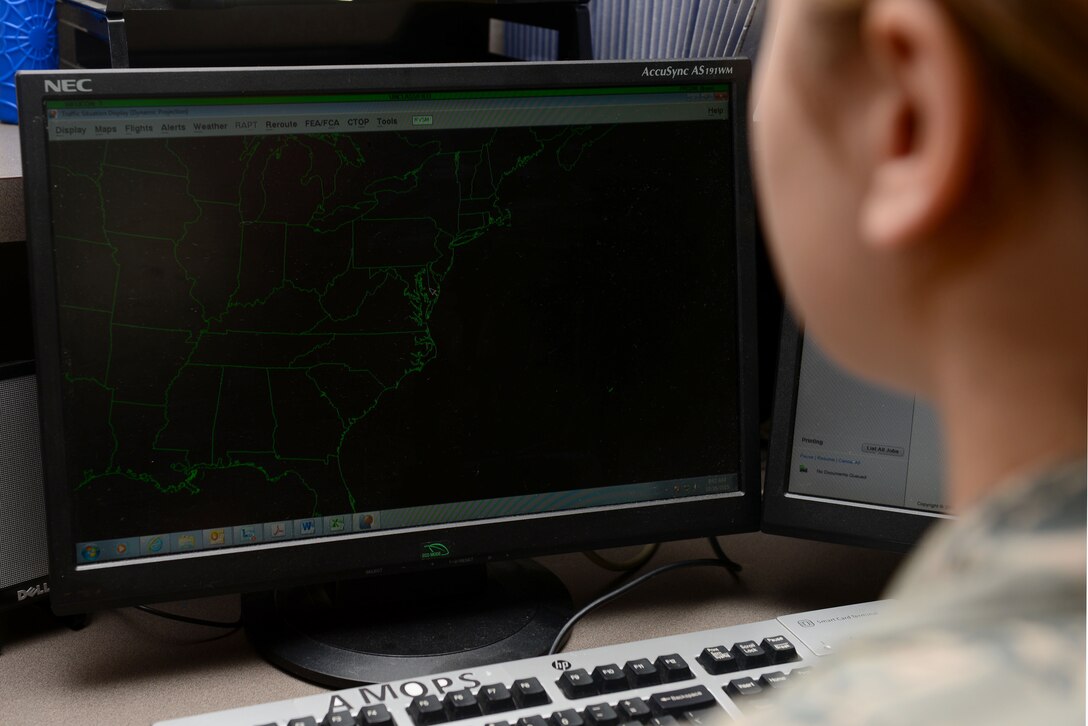 A U.S. Air Force Airman observes incoming and outgoing jets on a tracking system at Langley Air Force Base, Va., Oct. 16, 2015. Airfield management specialists constantly monitor all flight line activity to ensure safety for both personnel and resources. (U.S. Air Force photo by Airman 1st Class Derek Seifert/ Released)