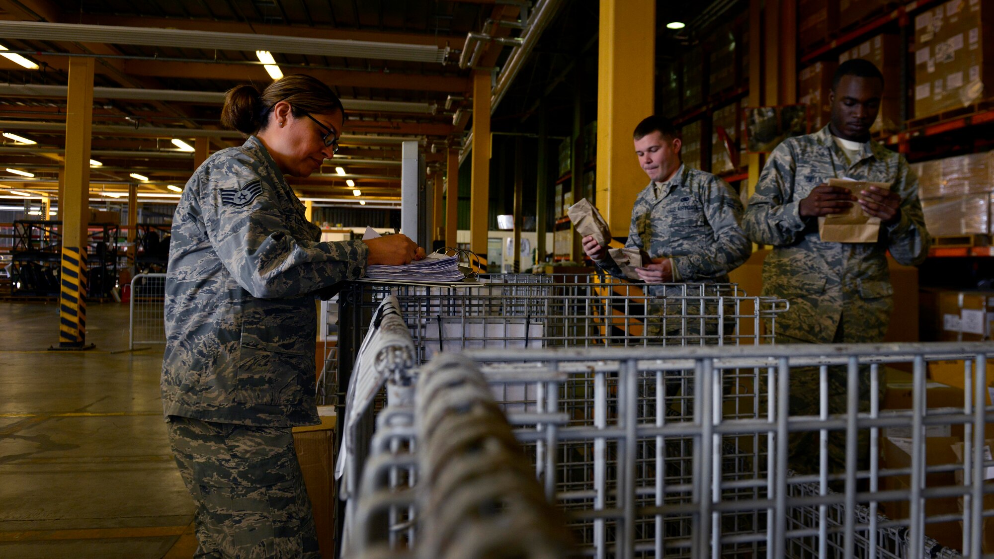 U.S. Air Force Staff Sgt. Maria DeLeon, 31st Logistics Readiness Squadron in-bound cargo supervisor, works with other Airmen to catalog supplies before pick-up, Oct. 20, 2015, at Aviano Air Base, Italy. DeLeon moved from Peru to the U.S., and received her citizenship after enlisting in the military. (U.S. Air Force photo by Airman 1st Class Cary Smith/Released)