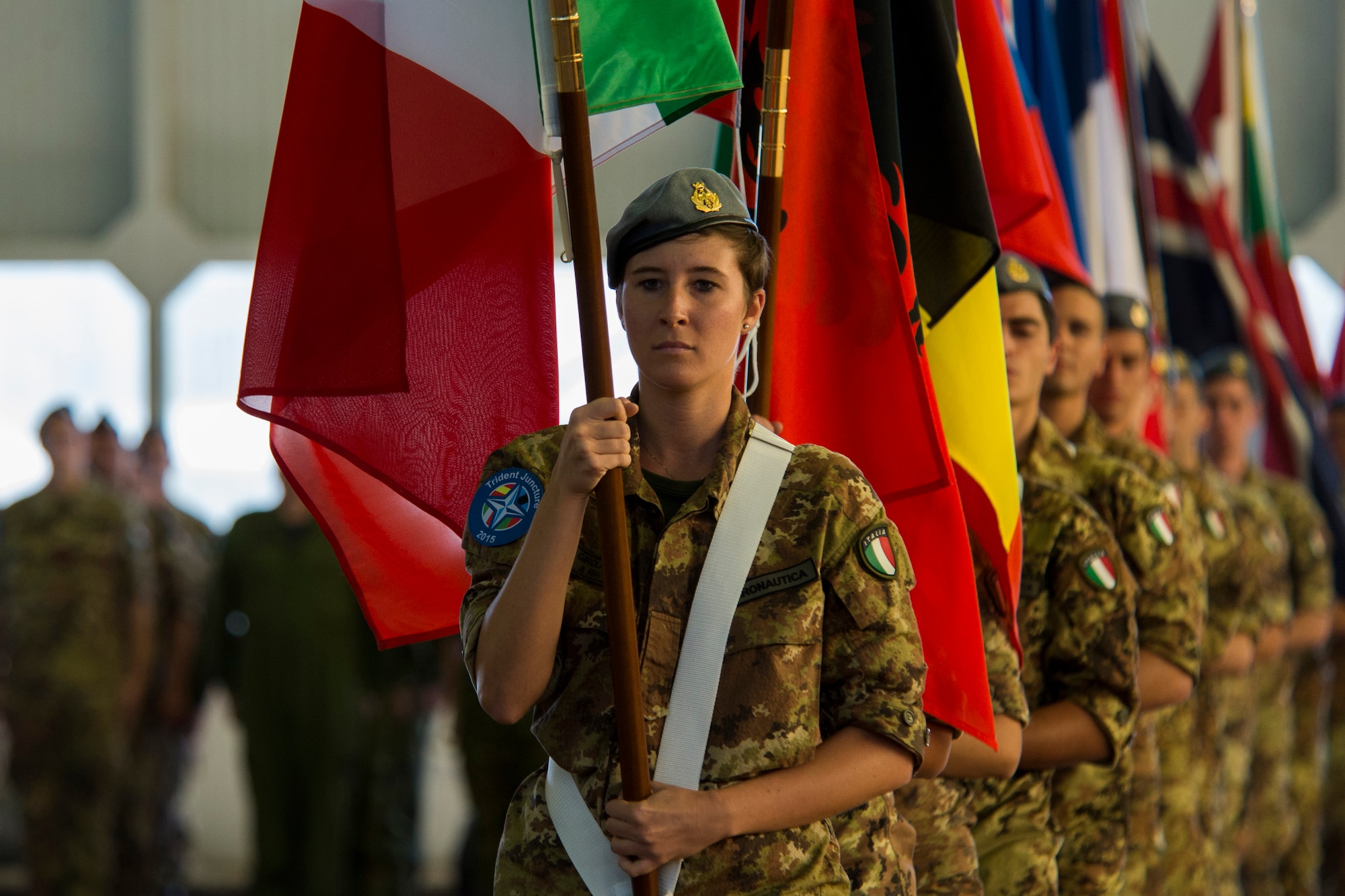 TRAPANI AIR BASE, Italy - Italian air force airmen carry more than 30 Allied and Partner Nations’ flags during a ceremony before the start of the Trapani Air Show at Trapani Air Base, Italy, Oct. 19, 2015. The flags represented each nation participating in Trident Juncture 2015, a training exercise taking place throughout Italy, Portugal, Spain, the Atlantic Ocean, the Mediterranean Sea, Canada, Norway, Germany, Belgium and the Netherlands. (U.S. Air Force photo by Airman 1st Class Luke Kitterman/Released)