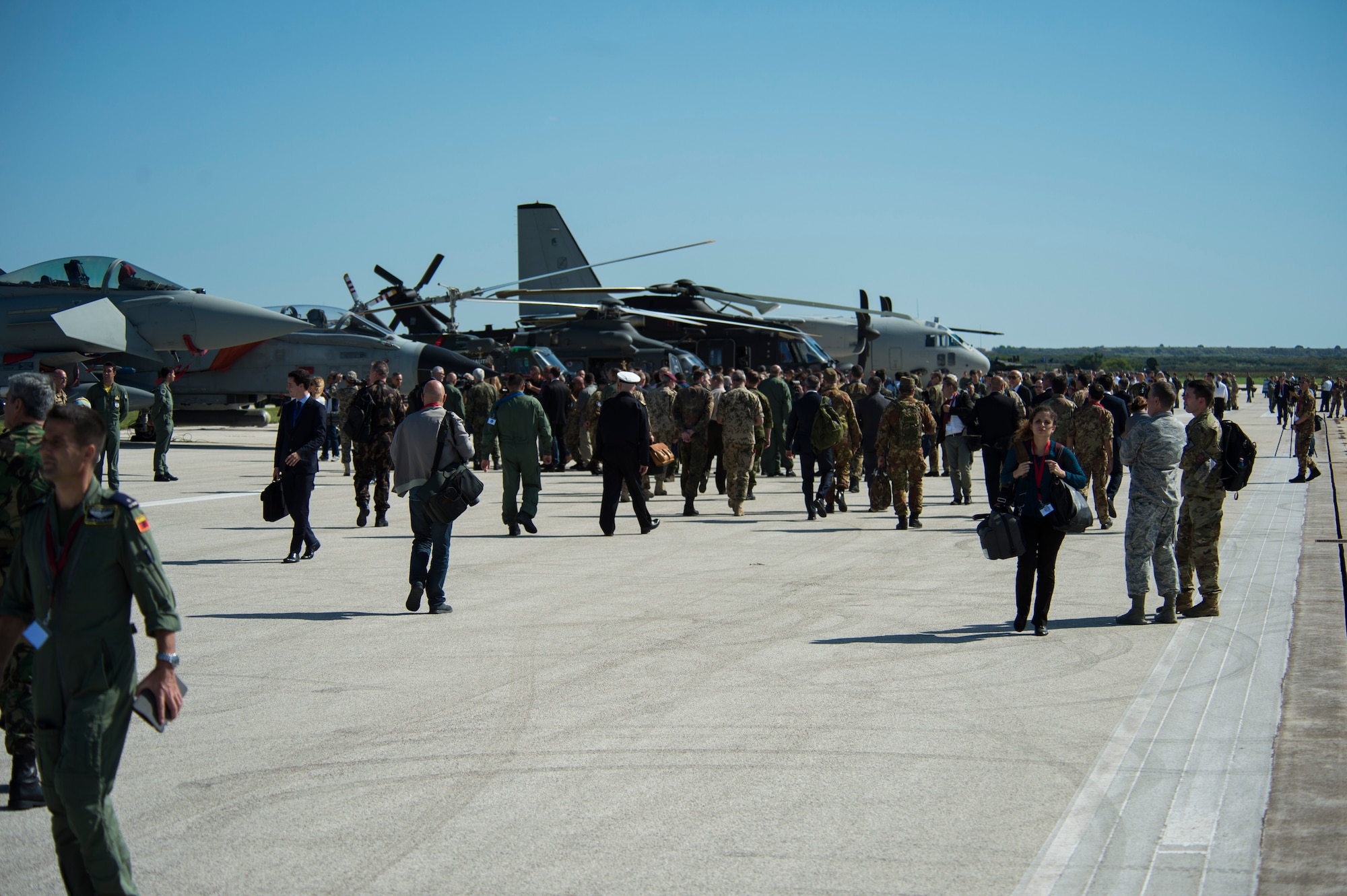 TRAPANI AIR BASE, Italy - Military members and media representatives from multiple nations observe static displays of aircraft during the Trapani Air Show at Trapani Air Base, Italy, Oct. 19, 2015. The Trapani Air Show kicked off Trident Juncture 2015, a training exercise involving more than 30 Allied and Partner Nations taking place throughout Italy, Portugal, Spain, the Atlantic Ocean, the Mediterranean Sea, Canada, Norway, Germany, Belgium and the Netherlands. (U.S. Air Force photo by Airman 1st Class Luke Kitterman/Released)